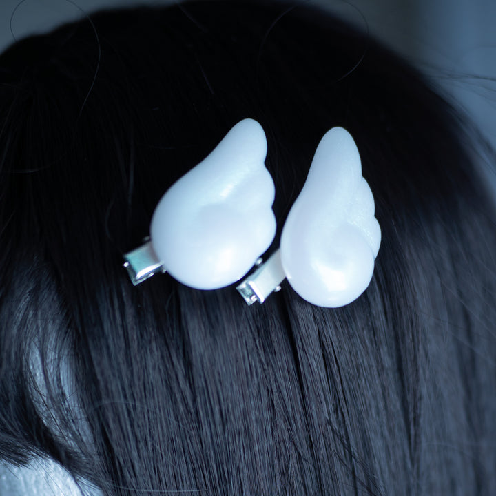 Angel Puffy Wing Clips by MOEFLAVOR, made from lightweight resin with an iridescent paint coating for a dreamy, color-shifting glow, adding a whimsical, celestial touch to your hair or outfit.