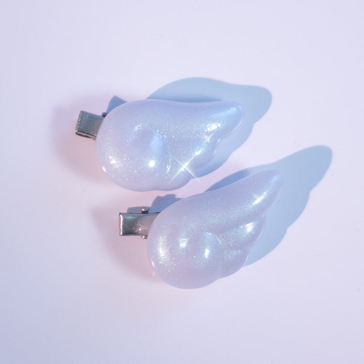 Angel Puffy Wing Clips by MOEFLAVOR, made from lightweight resin with an iridescent paint coating for a dreamy, color-shifting glow, adding a whimsical, celestial touch to your hair or outfit.