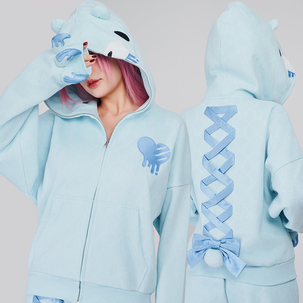 Pastel Winter Hoodie Blue by MOEFLAVOR. A full-zip hoodie transforming into Gloomy Bear's face, featuring bear ears, embroidered details, clawed cuffs, lace-up back with bow, puffy tail, and fleece lining for warmth.