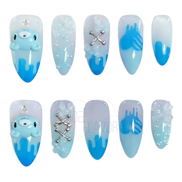 Blue press-on nails by MOEFLAVOR, handmade by Clawstrike, inspired by the Gloomy Bear collection. Bold nails with an edgy, heavenly touch to complete style.