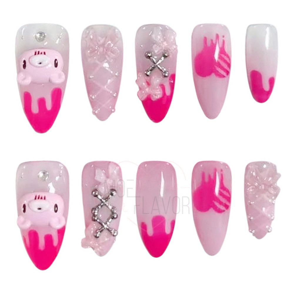 Pink press-on nails by MOEFLAVOR, handmade by Clawstrike, inspired by the Gloomy Bear collection. Bold nails with an edgy, heavenly touch to complete style.