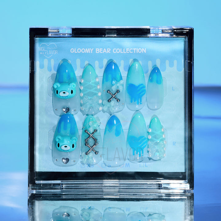 Blue press-on nails by MOEFLAVOR, handmade by Clawstrike, inspired by the Gloomy Bear collection. Bold nails with an edgy, heavenly touch to complete style.